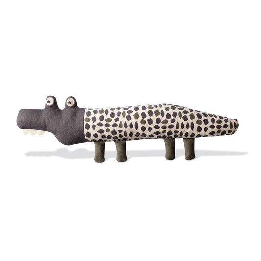 Toy alligator with a spotted pattern on a white background