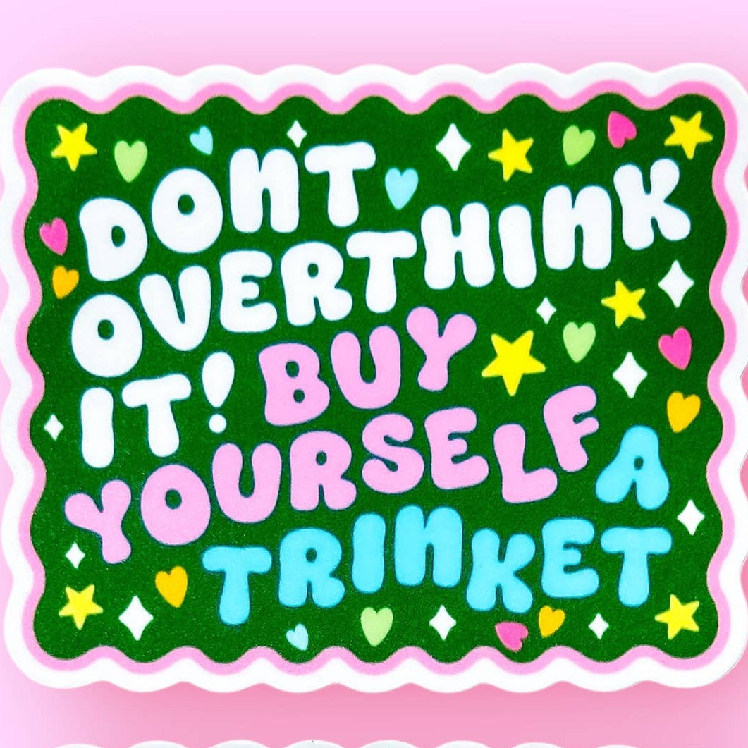 Two colorful stickers with motivational text on a pink background