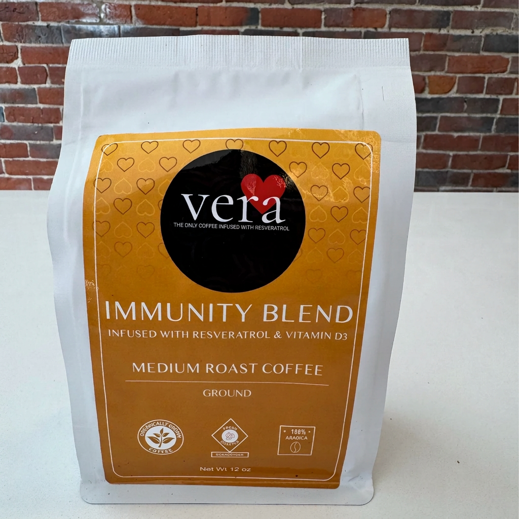 Vera Immunity Blend coffee package on a white surface with a brick wall background