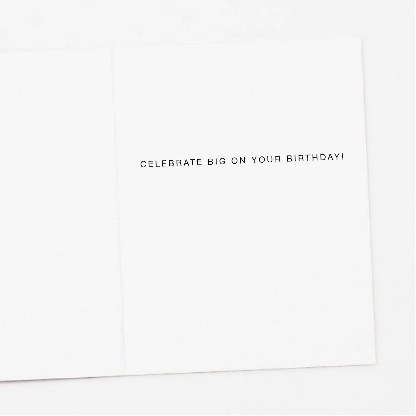 White card with black text 'Celebrate Big on Your Birthday!' on a white background