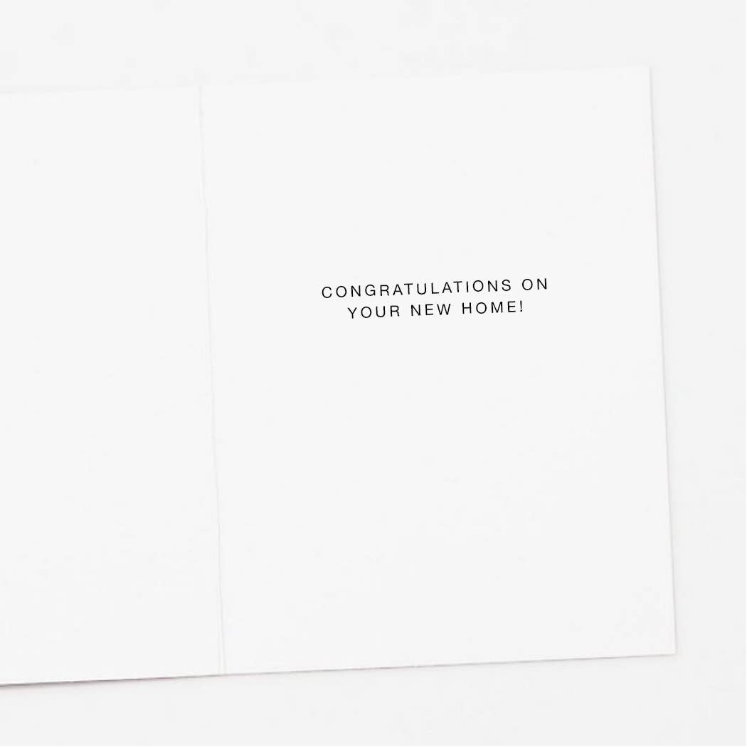 White card with black text 'Congratulations on your new home!' on a white background