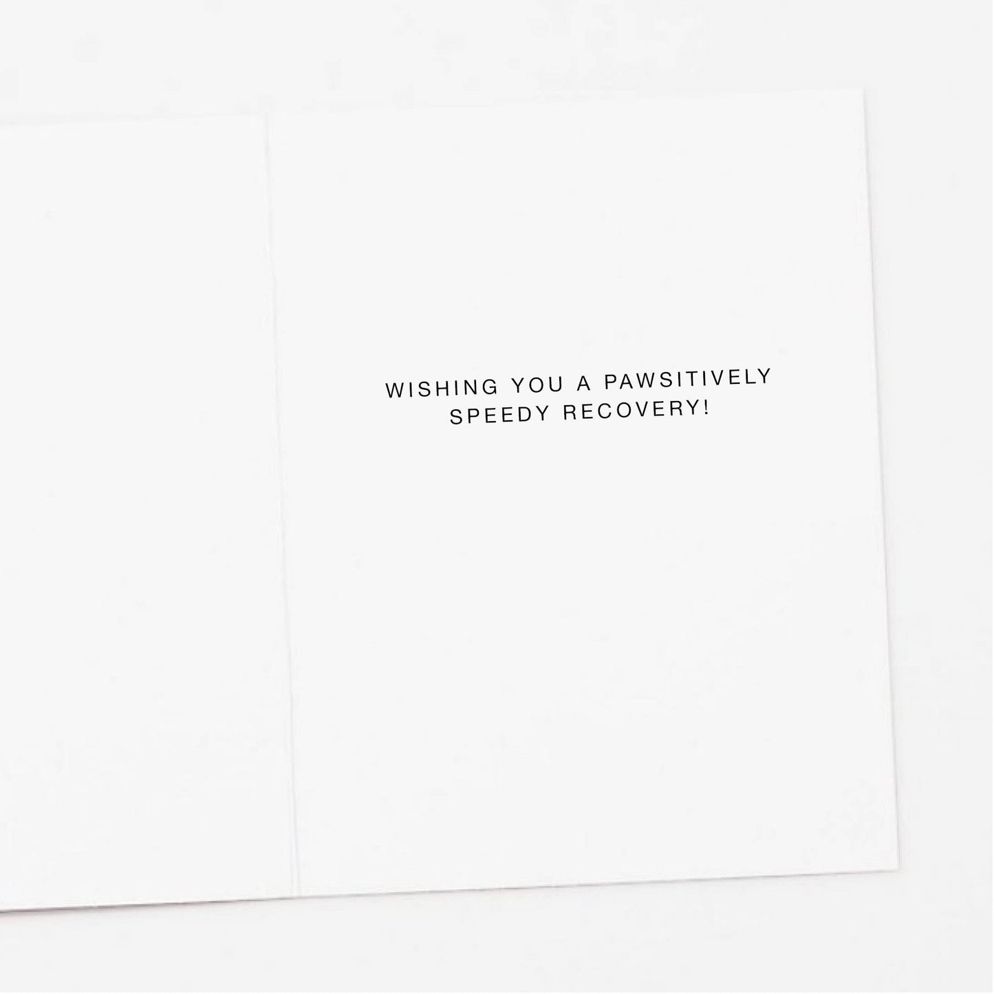 White card with black text wishing a speedy recovery