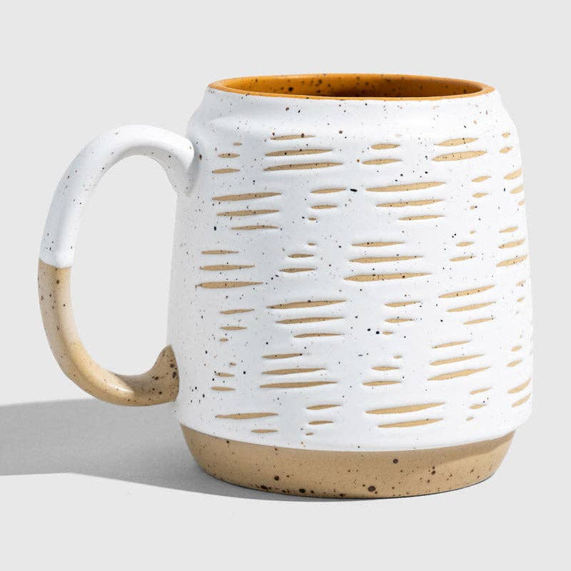 White ceramic mug with brown accents on a light gray background