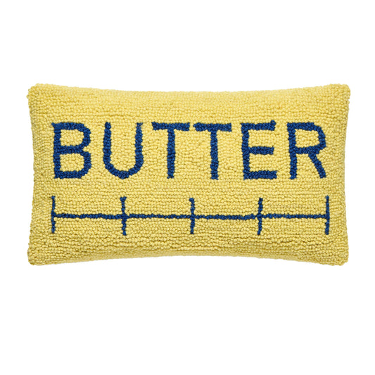 Yellow pillow with 'BUTTER' text on a white background