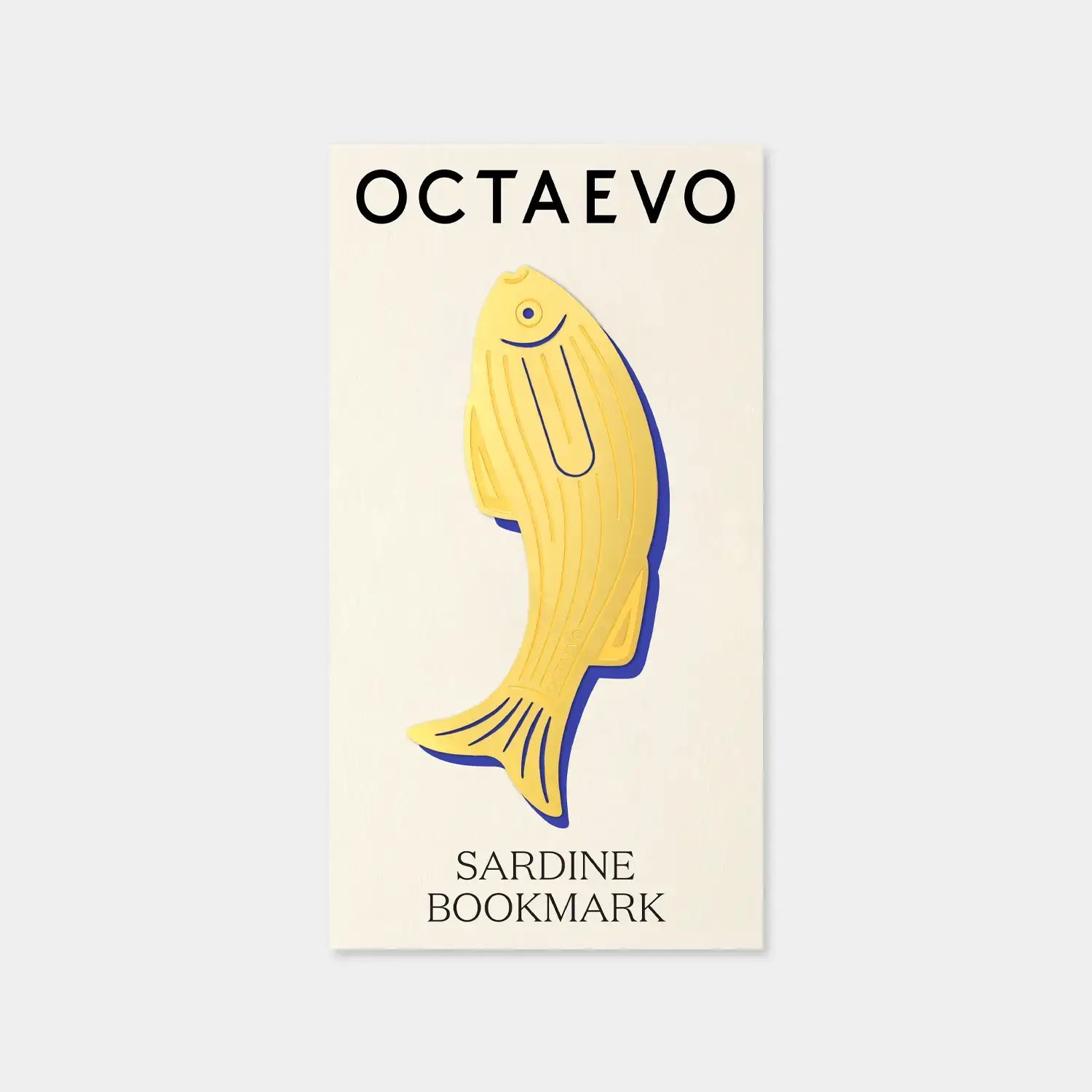 Yellow sardine-shaped bookmark with 'Octaevo' branding on a beige background