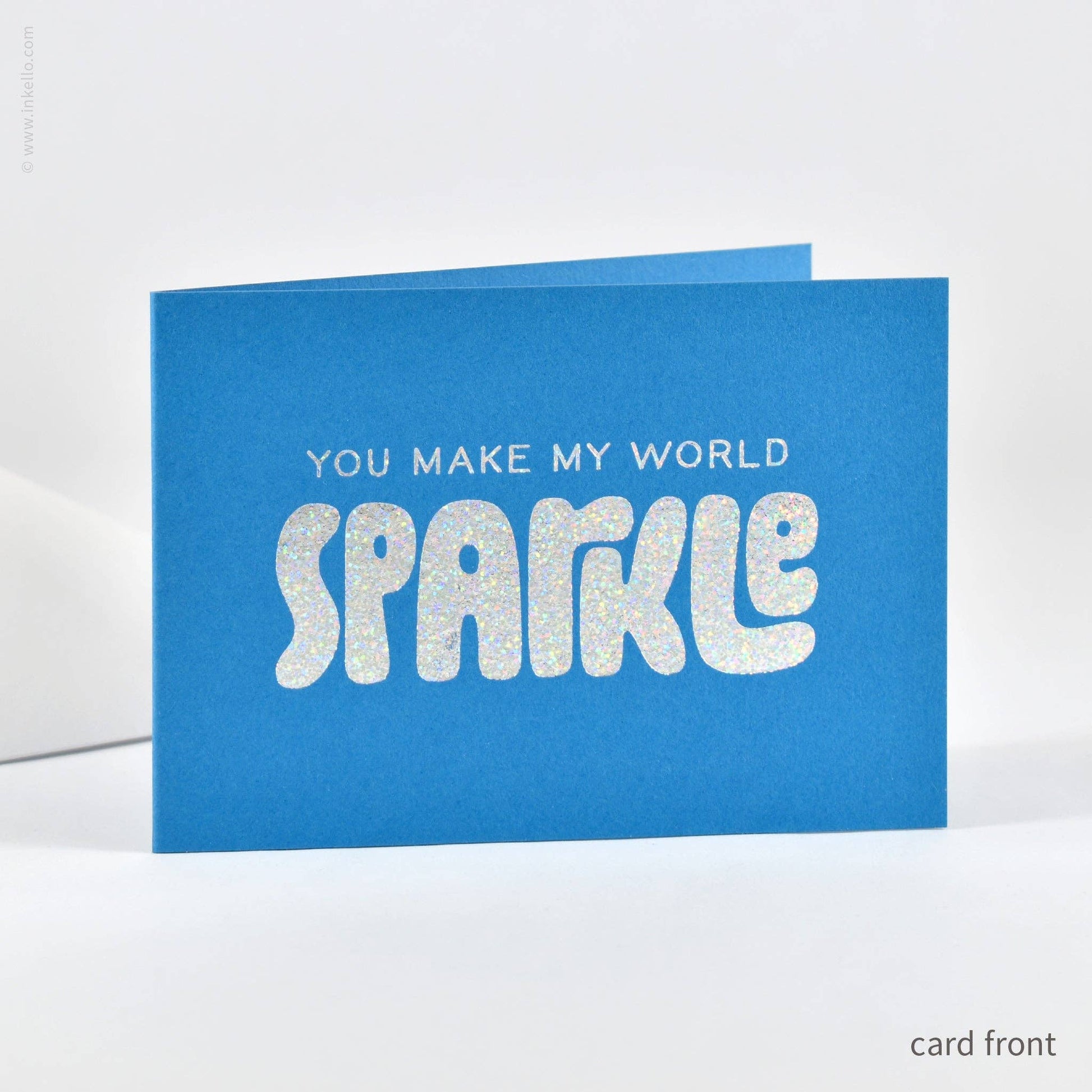 Blue card with 'You make my world sparkle' text on a white background