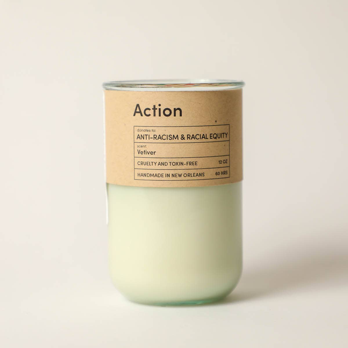 Candle with a brown label on a beige background
