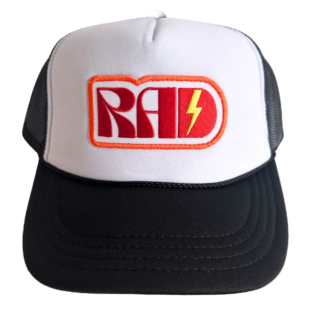 White and black cap with 'RAD' logo featuring a red and yellow lightning bolt on a white background