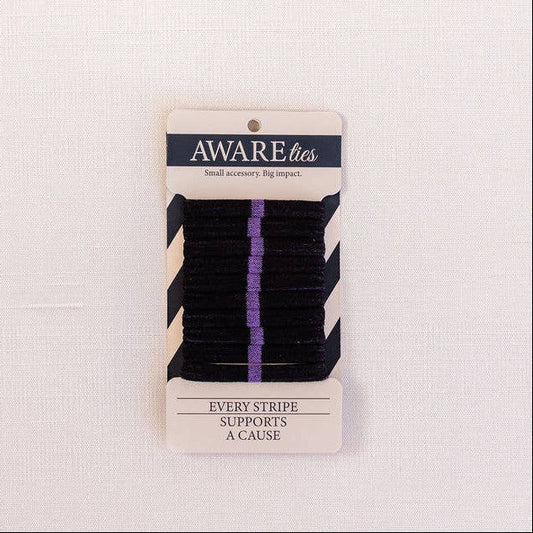 Pack of black hair ties with a 'Aware' brand label on a light pink background