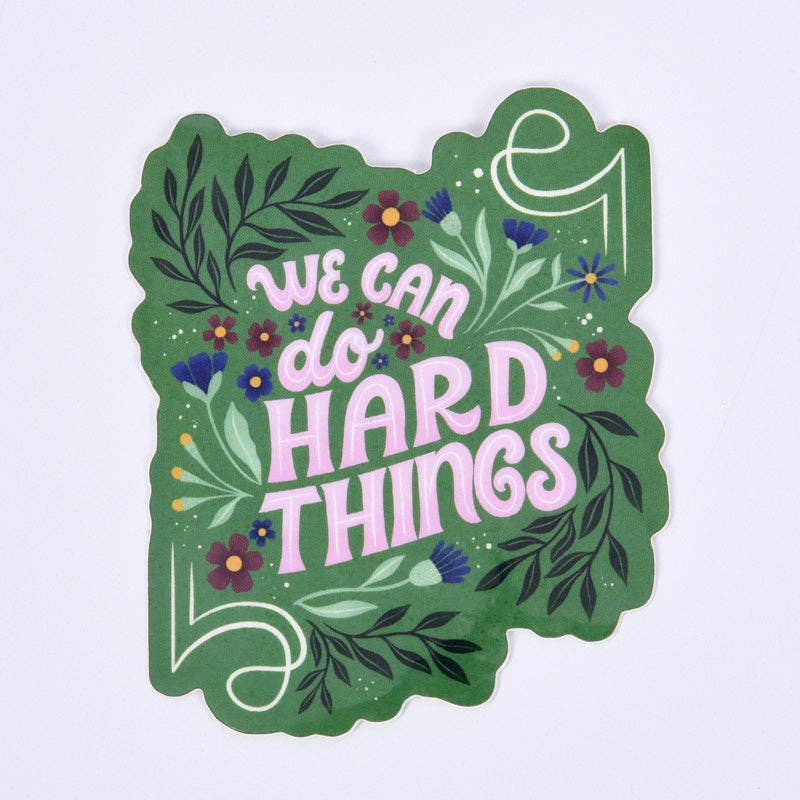 Decorative sticker with 'We can do hard things' text on a green background