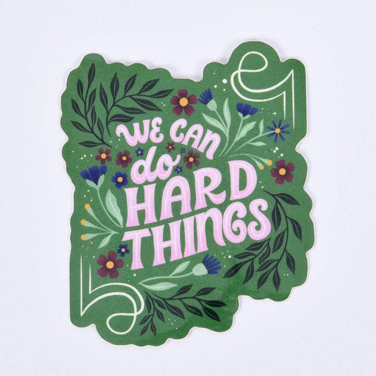 Decorative sticker with 'We can do hard things' text on a green background