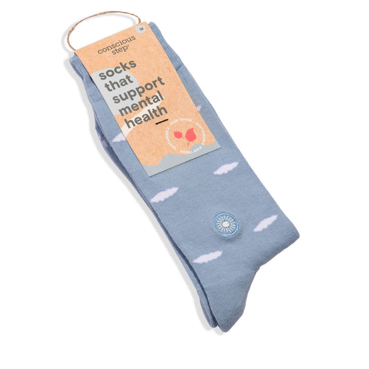Blue sock with white heart patterns and a visible brand label on a white background