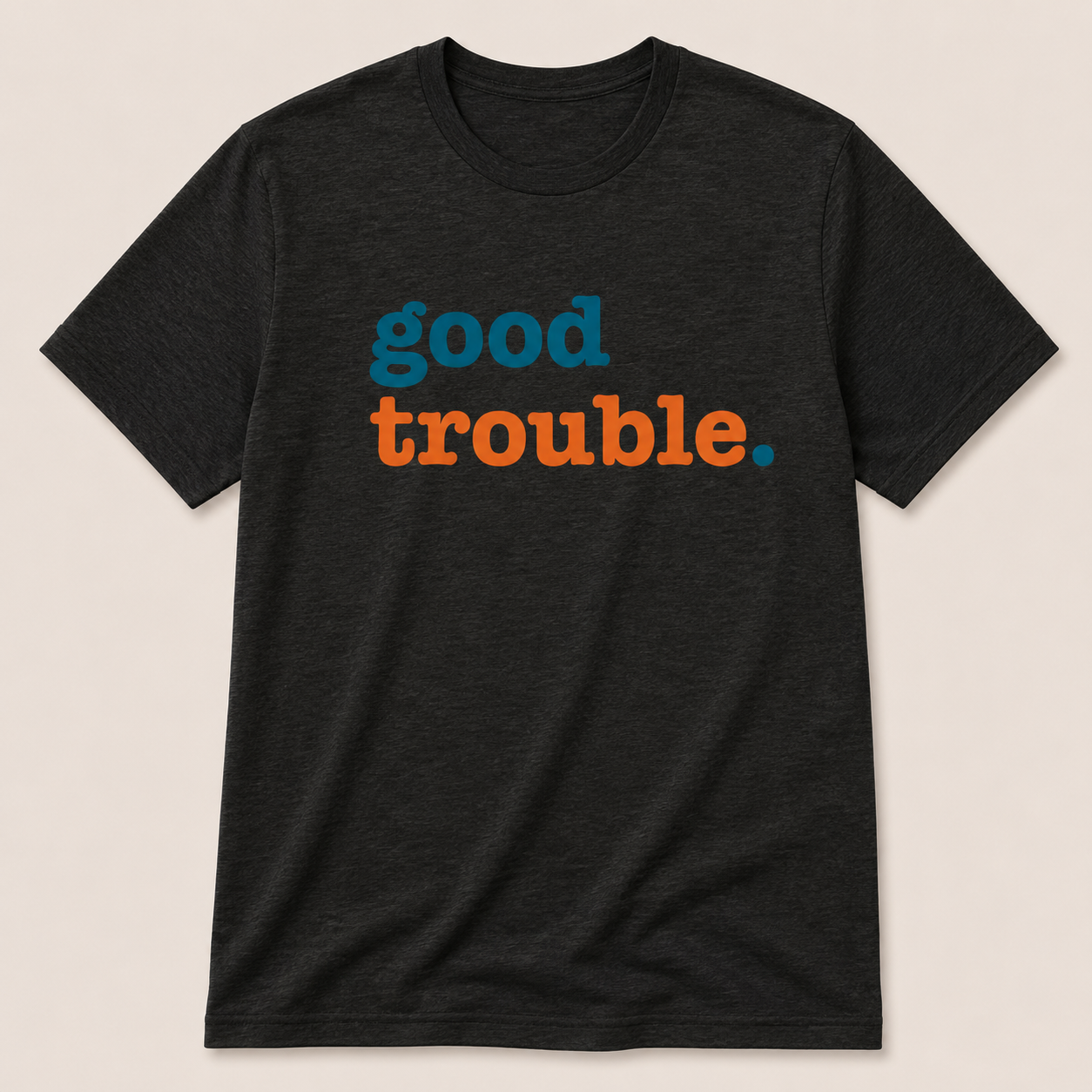 Black t-shirt with 'good trouble' text in blue and orange on a beige background