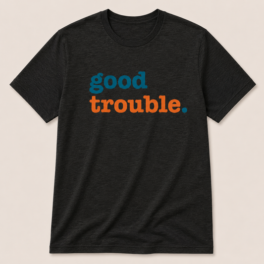 Black t-shirt with 'good trouble' text in blue and orange on a beige background