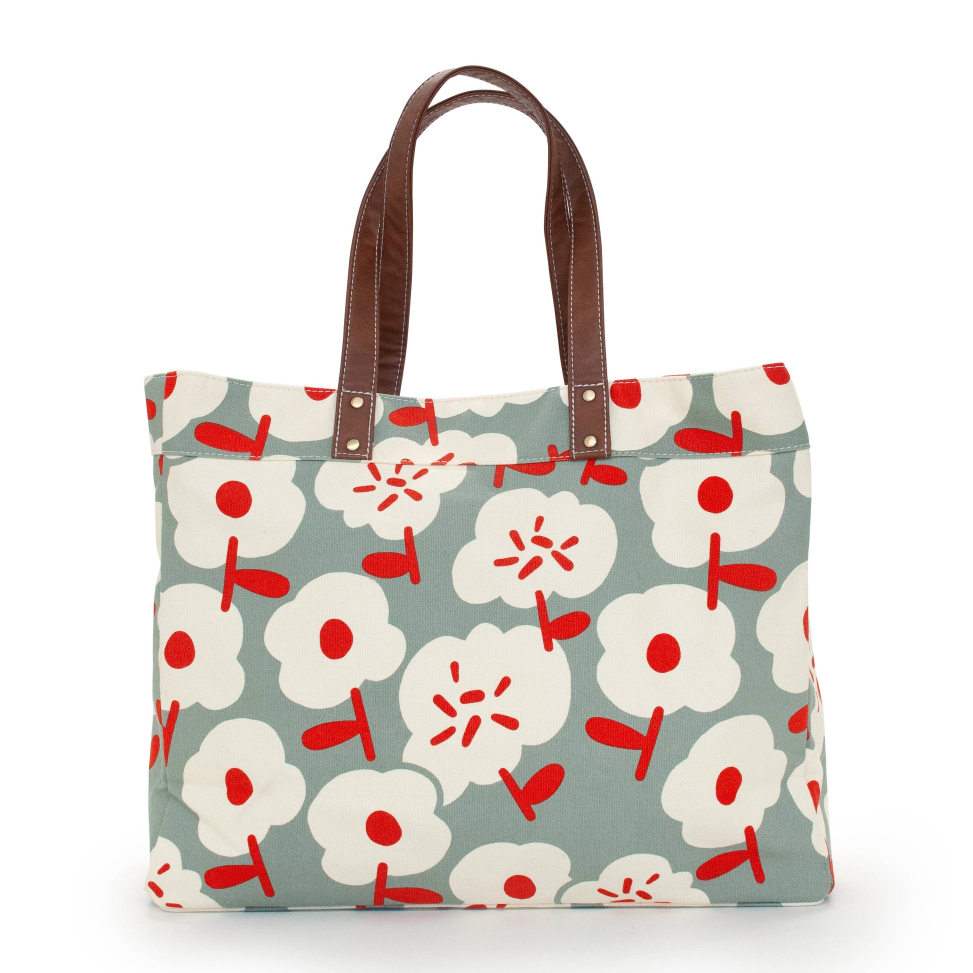 Floral patterned tote bag with brown handles on a white background