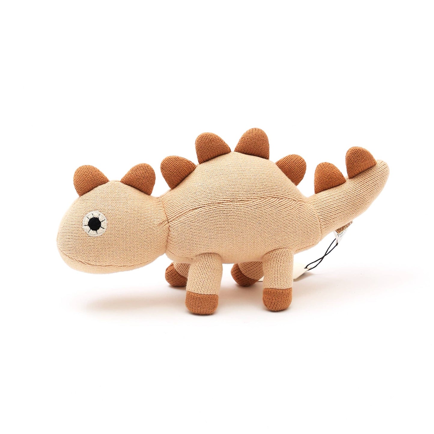 Plush dinosaur toy with brown spikes on a white background
