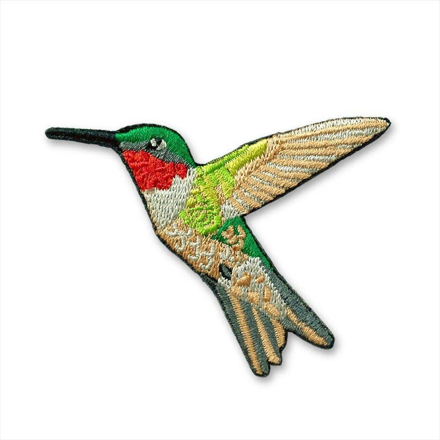 Embroidered patch of a colorful hummingbird on a white background