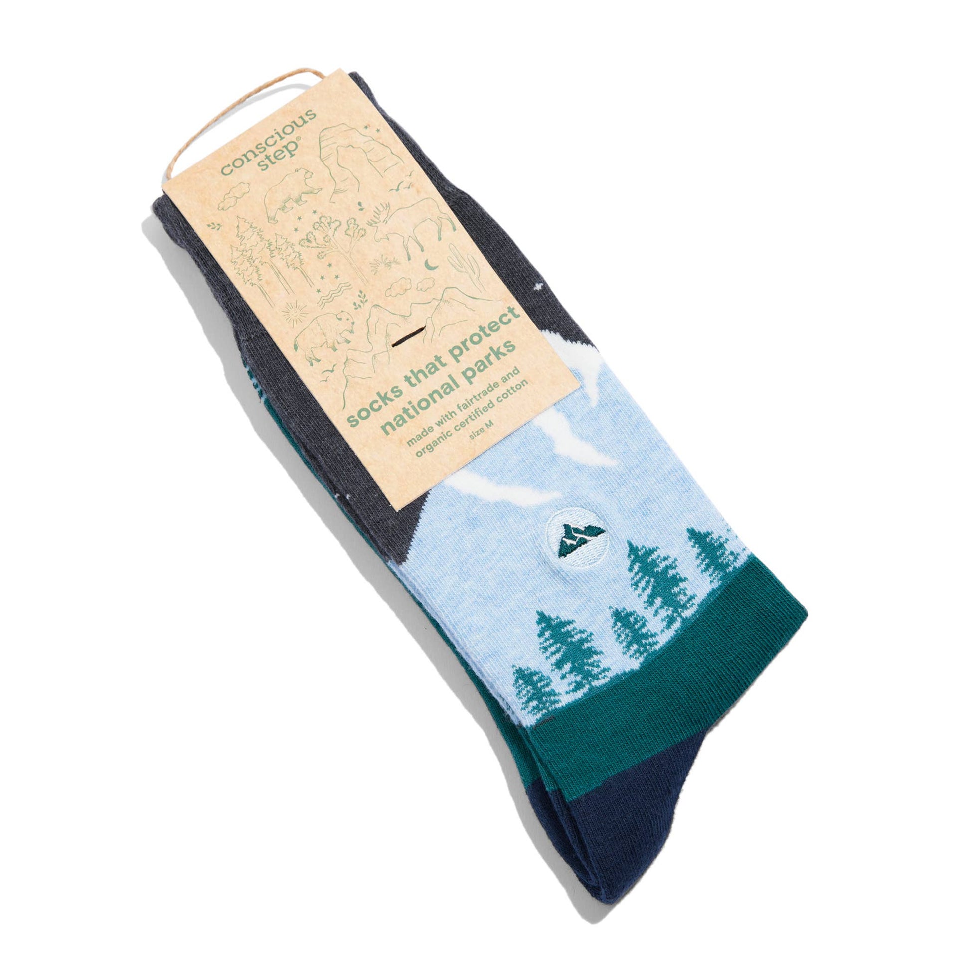 Pair of socks with a nature design and a cardboard tag on a white background