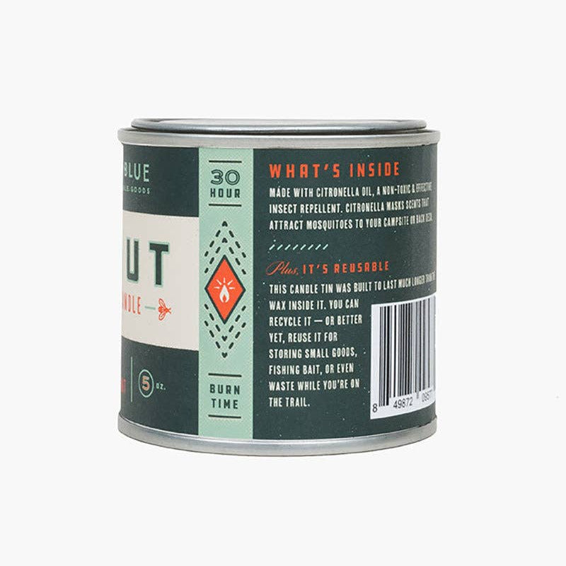 Back label of a candle tin with text and branding on a white background