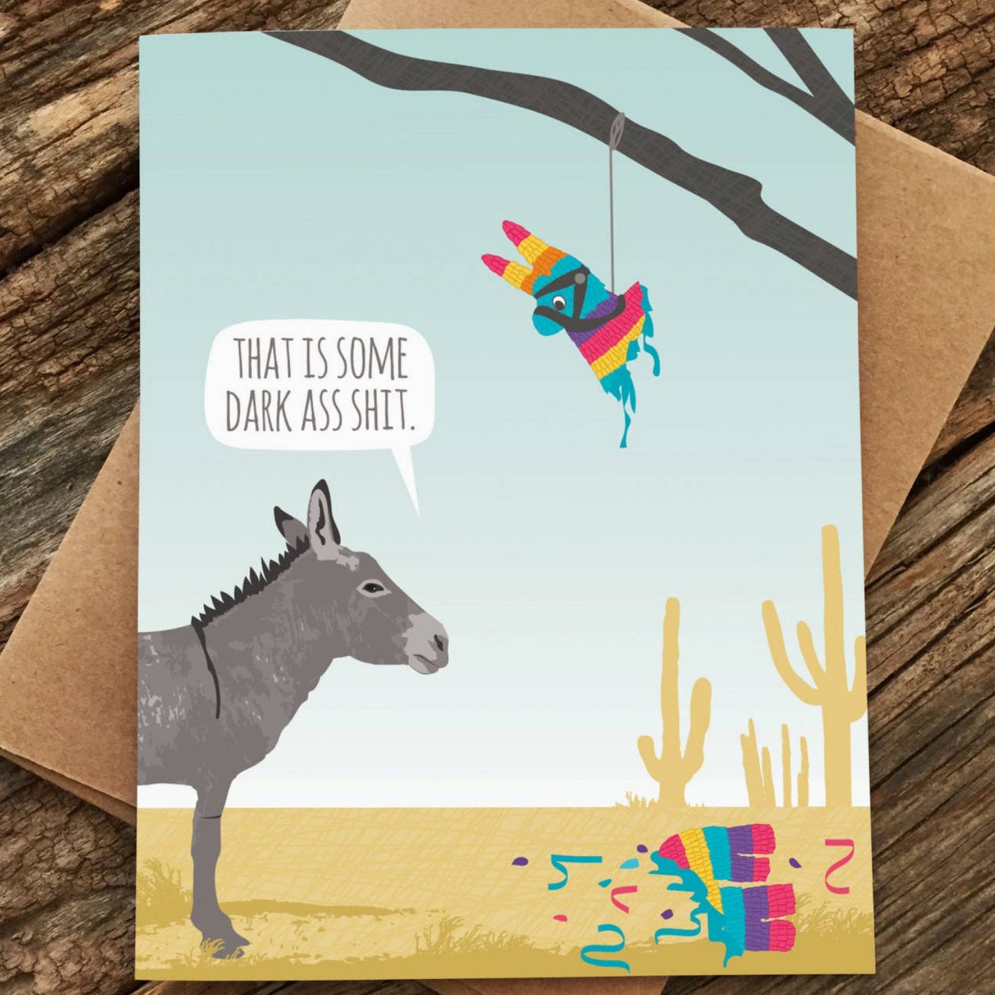 Card with a donkey and piñata on a wooden surface