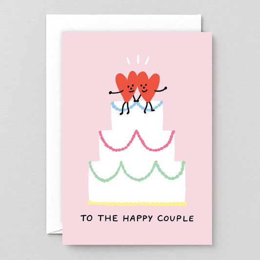 Greeting card with two hearts on a cake and text 'To the happy couple' on a pink background