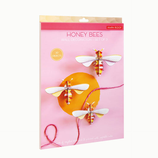Pack of honey bee-themed products with a pink background and bee illustrations.