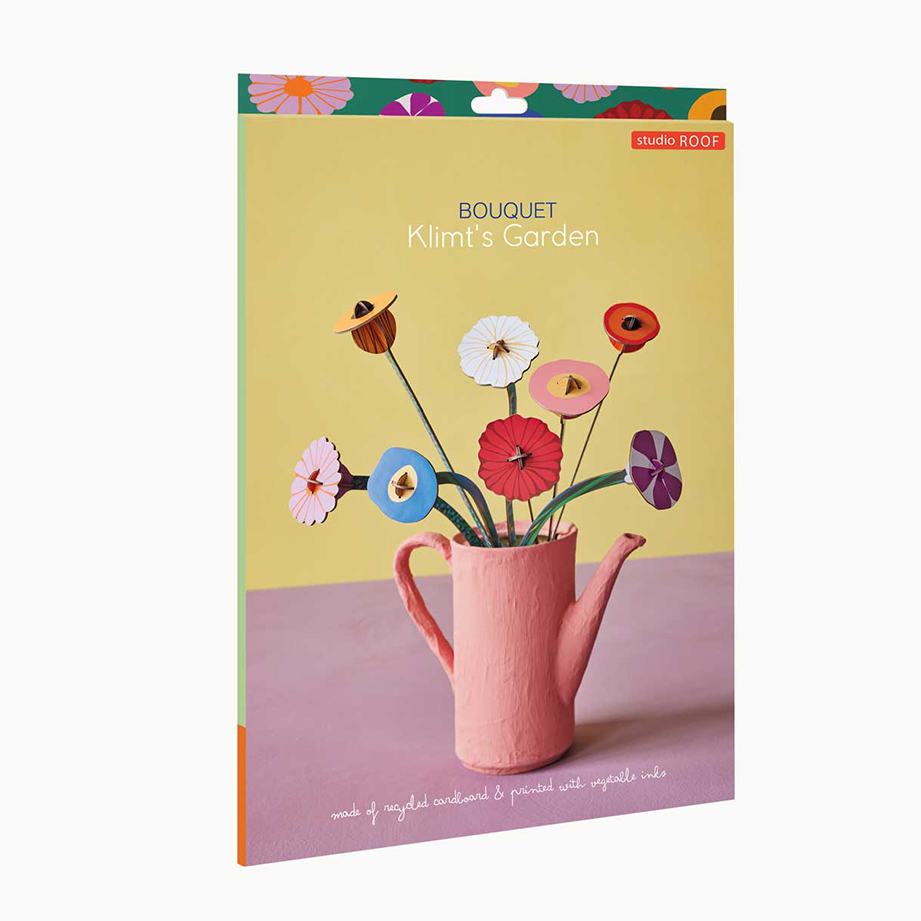 Notebook with a design of flowers in a pink watering can on a yellow background