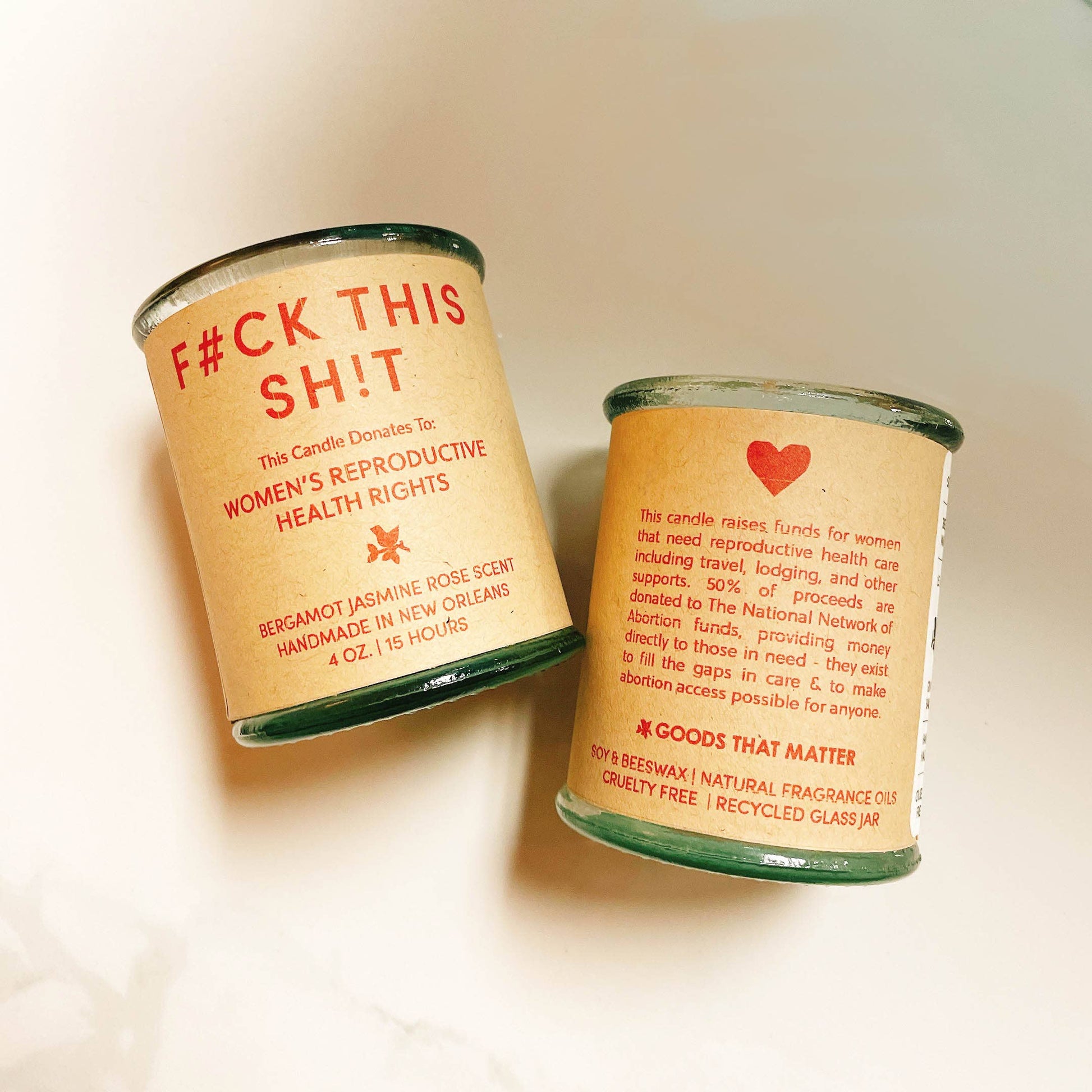 Two candles in glass jars with text on a beige background