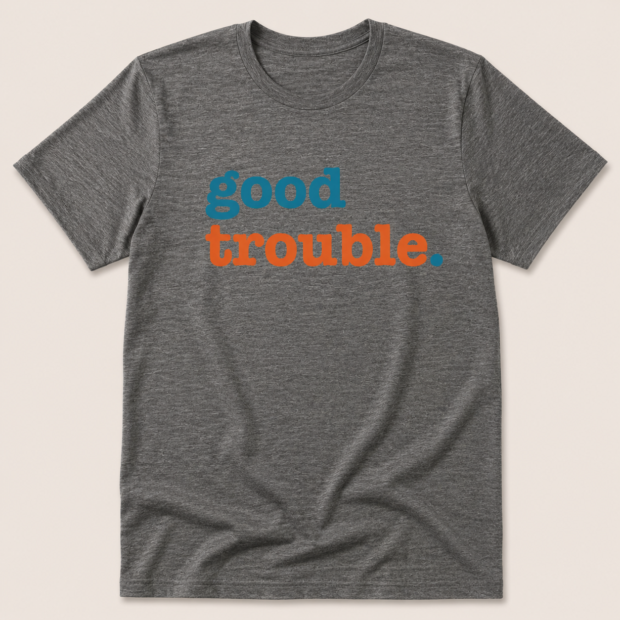 Gray t-shirt with 'good trouble' text in blue and orange on a beige background