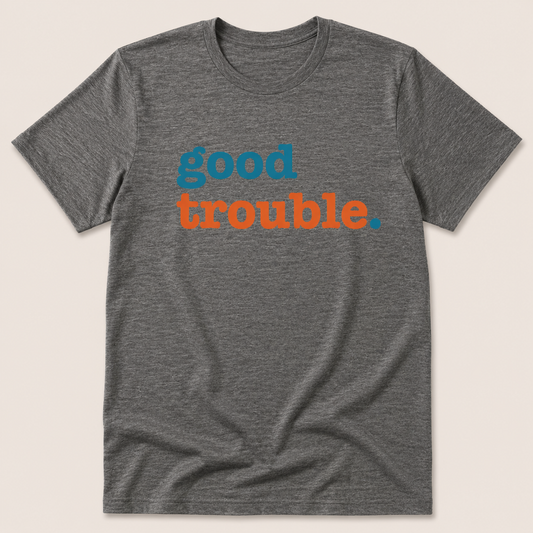 Gray t-shirt with 'good trouble' text in blue and orange on a beige background