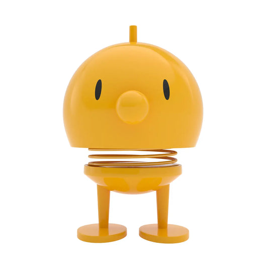 Yellow robot-like figure with a springy body on a white background