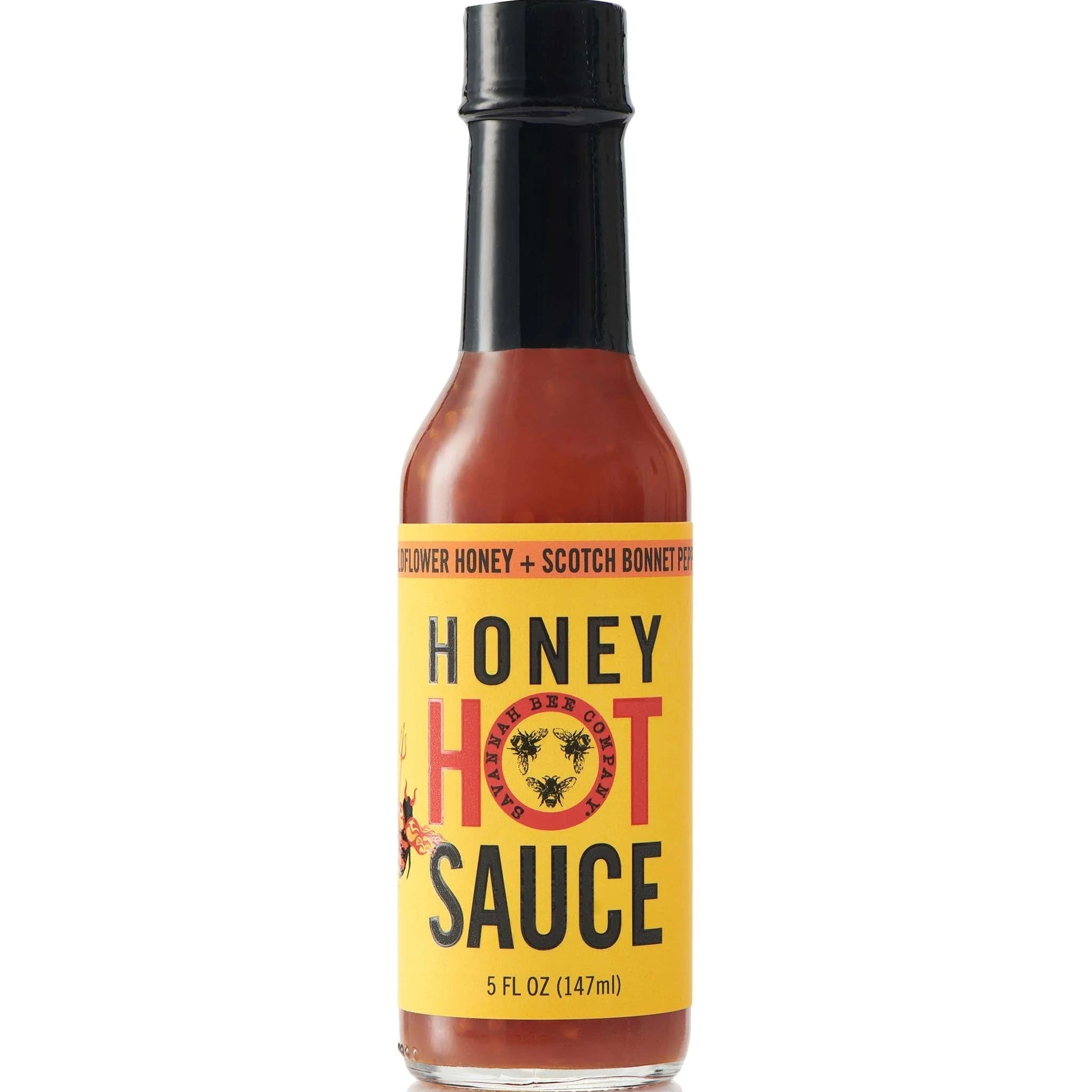 Bottle of honey hot sauce with a yellow label on a white background