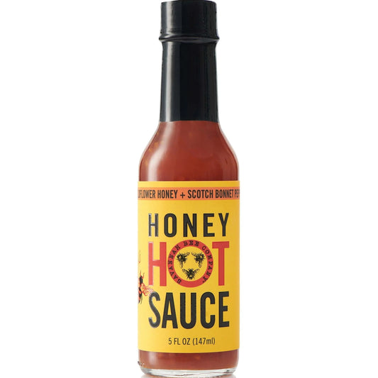 Bottle of honey hot sauce with a yellow label on a white background