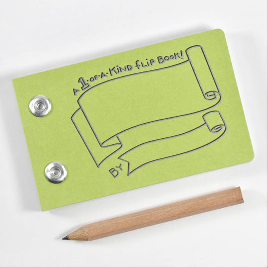 Small green flip book with a pencil on a white background