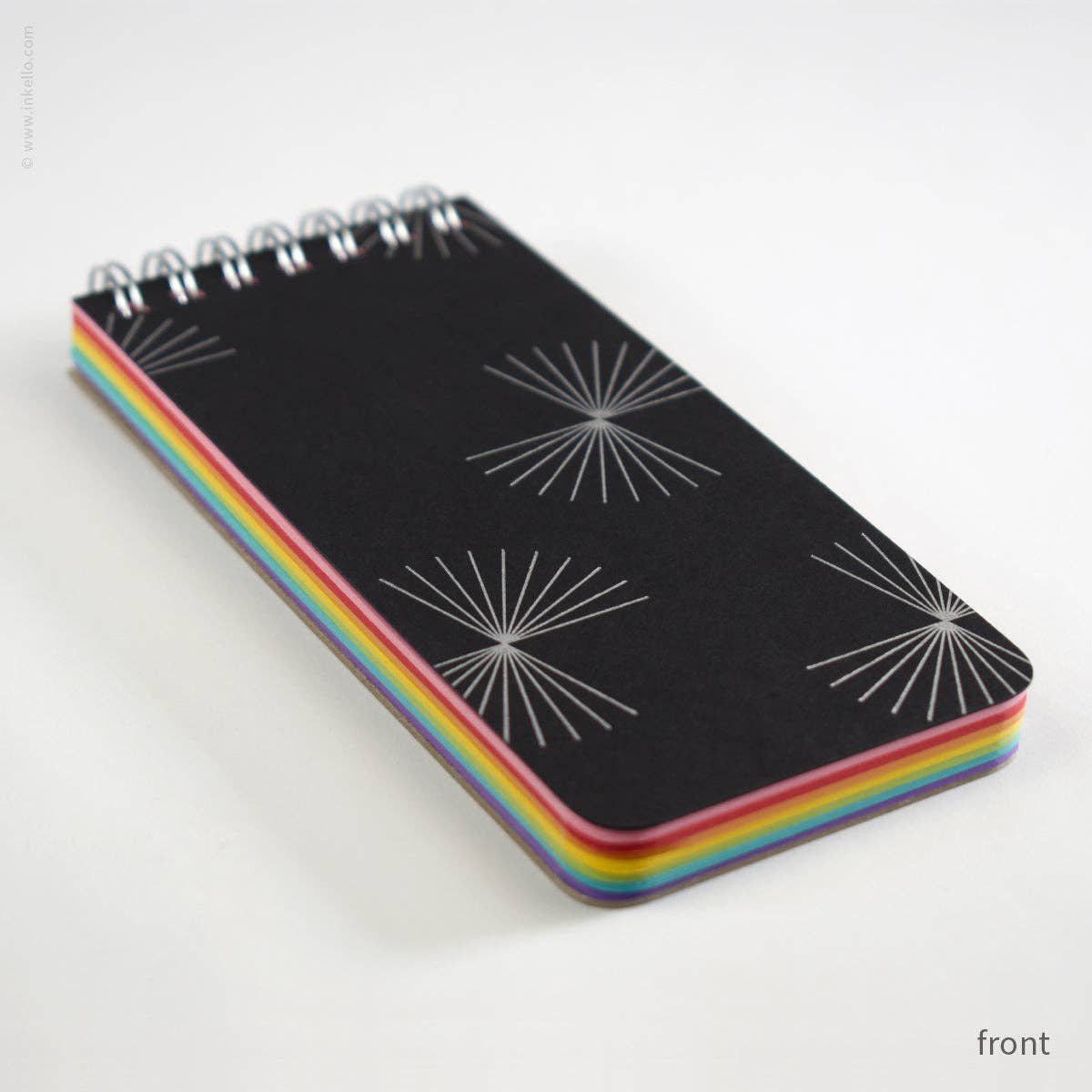 Stack of black notebooks with rainbow binding on a white background