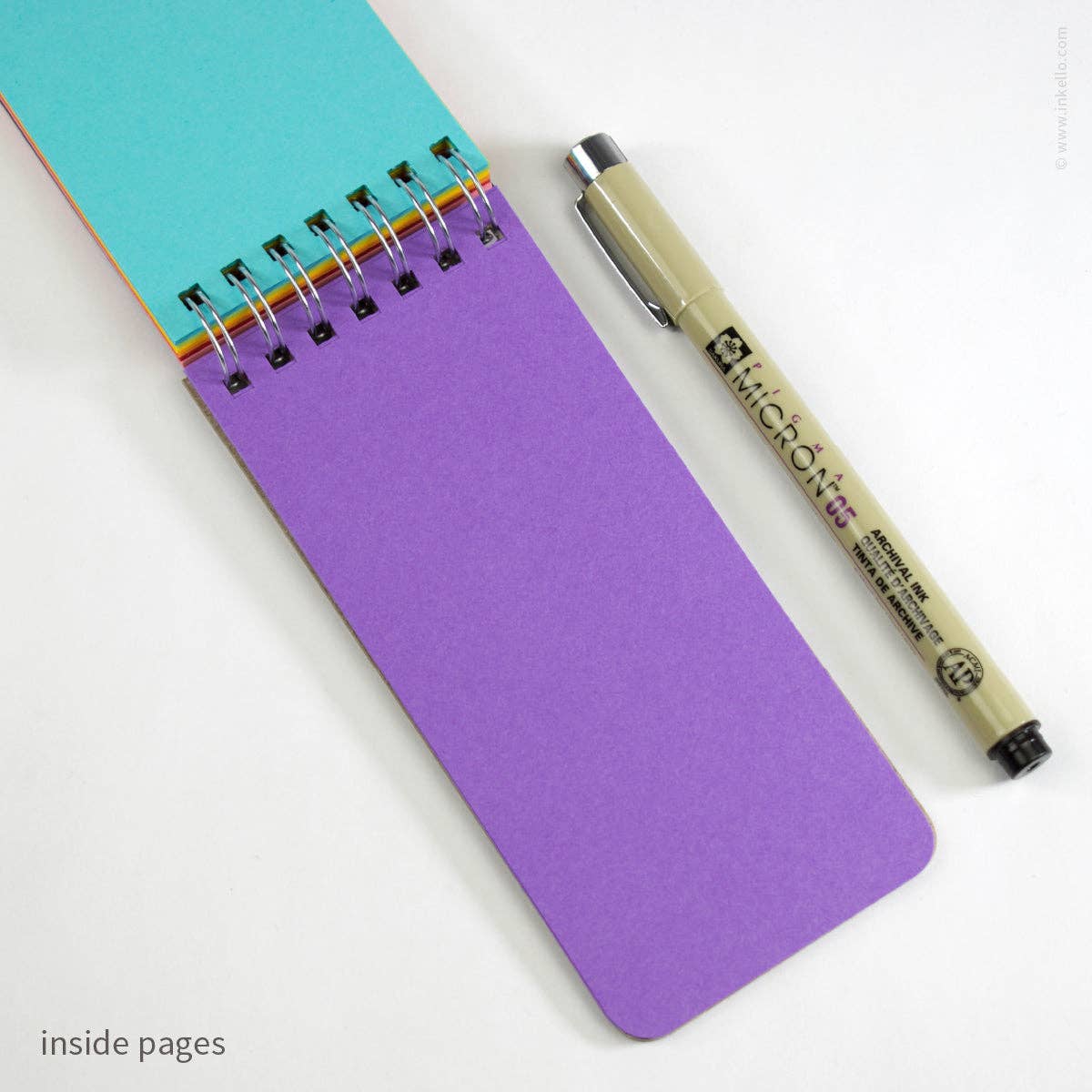 Purple notepad with a pen on a white background