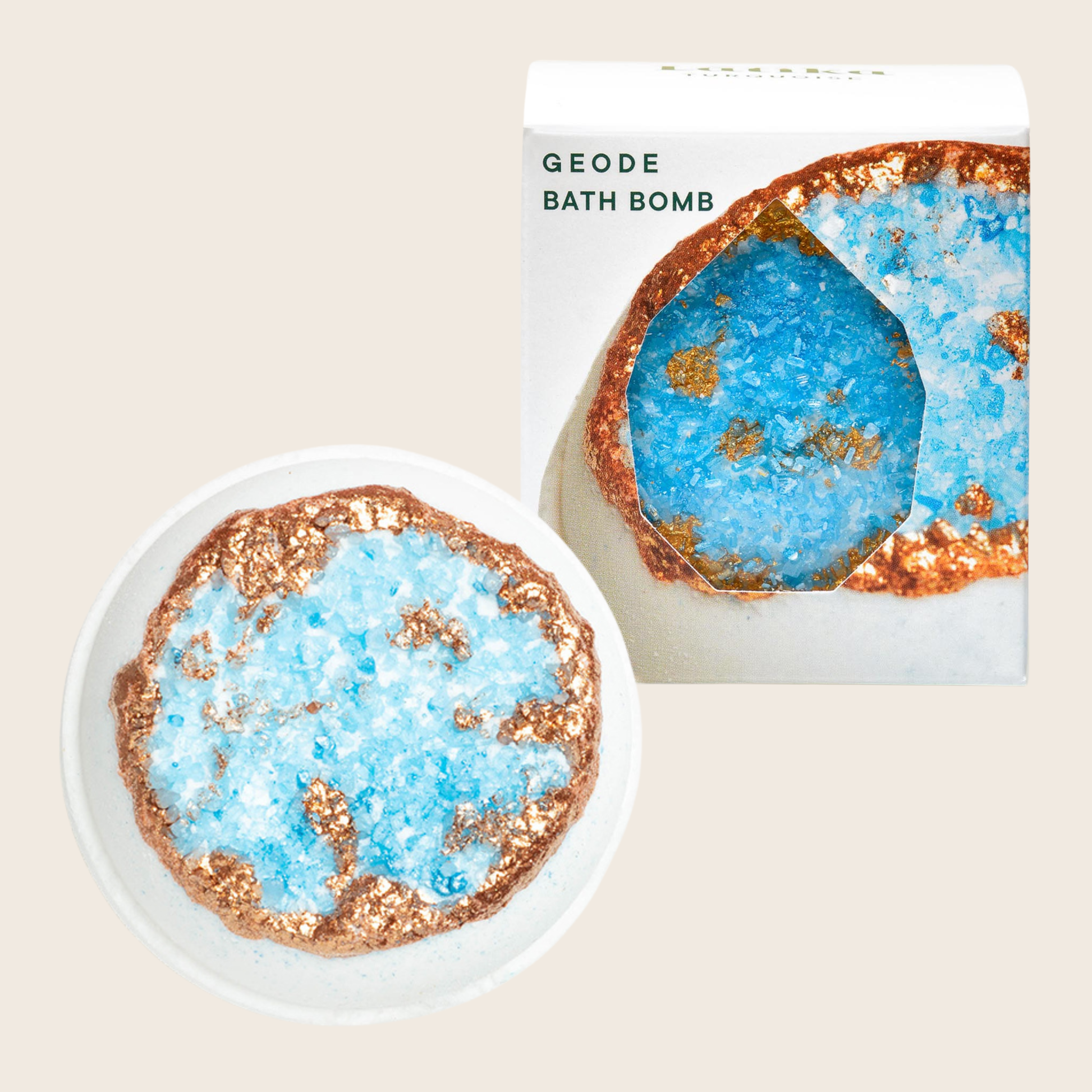 Geode bath bomb with packaging on a beige background