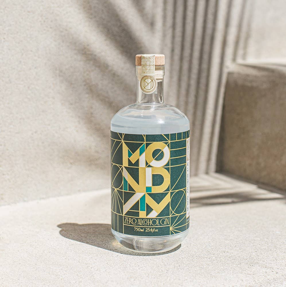 Bottle of Mondo Aperitivo on a textured surface with soft lighting