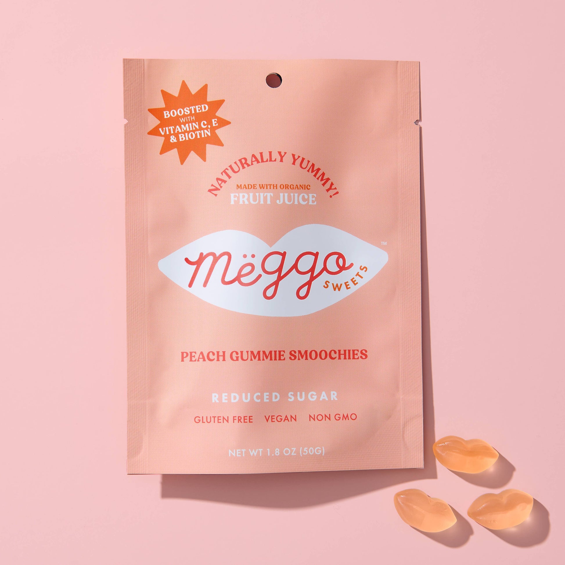 Megg sweets peach gummy smoochies package on a pink background