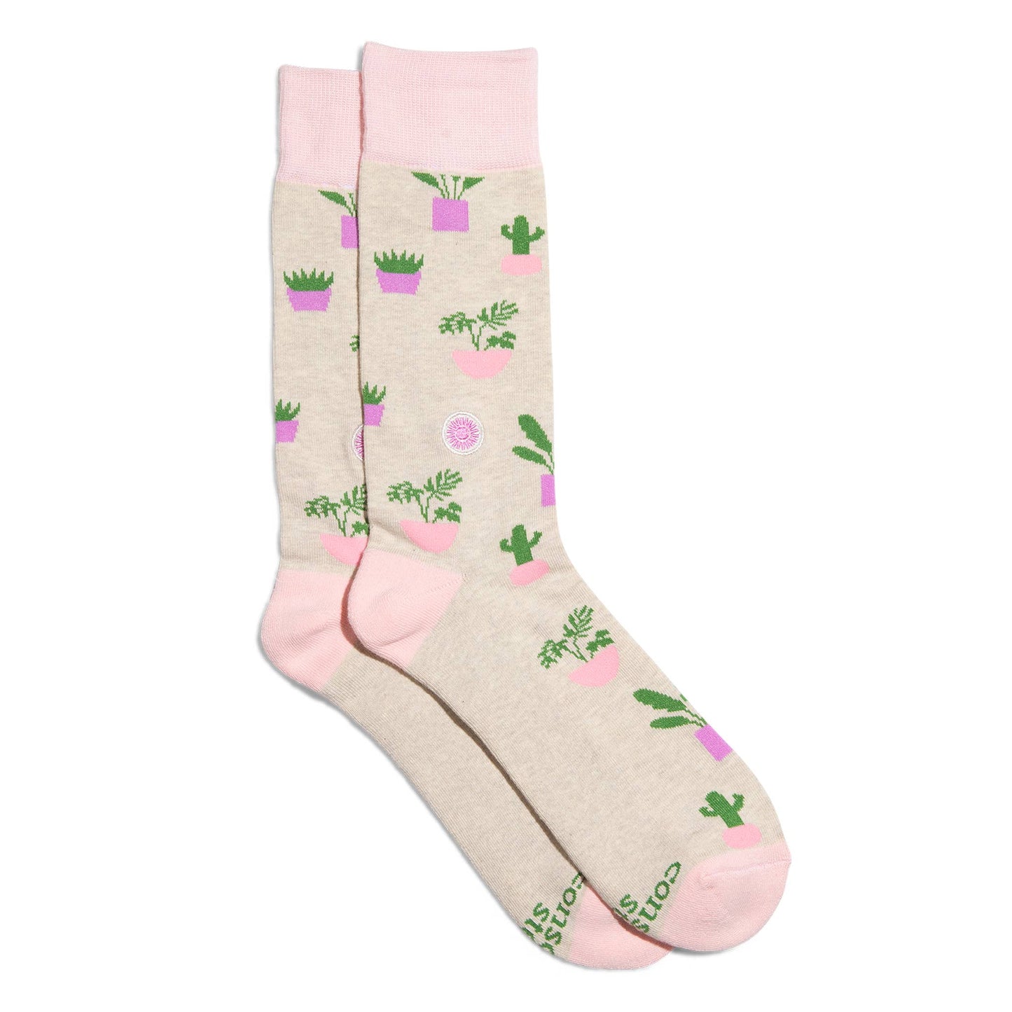 Beige socks with pink accents and cactus plant pattern on a white background