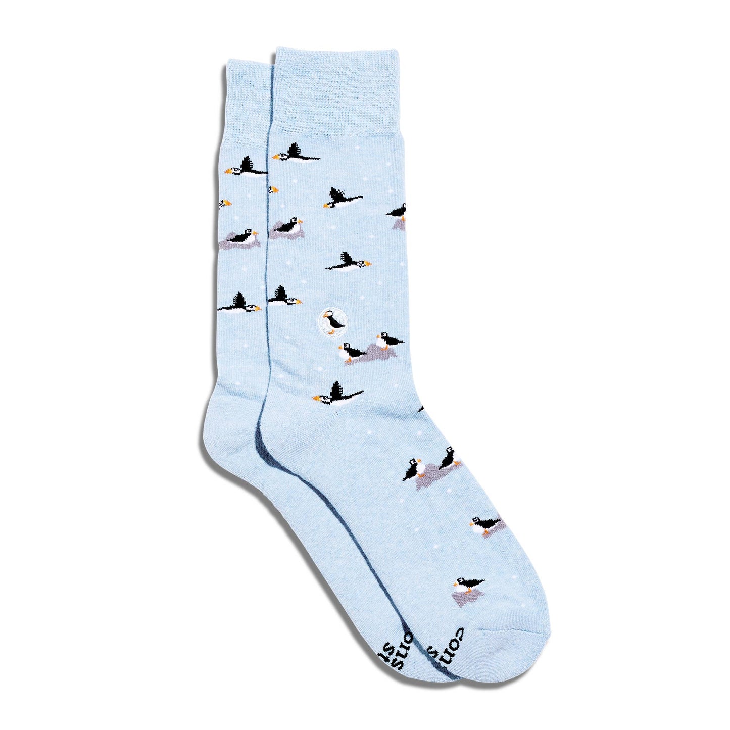 Light blue socks with puffin pattern on a white background