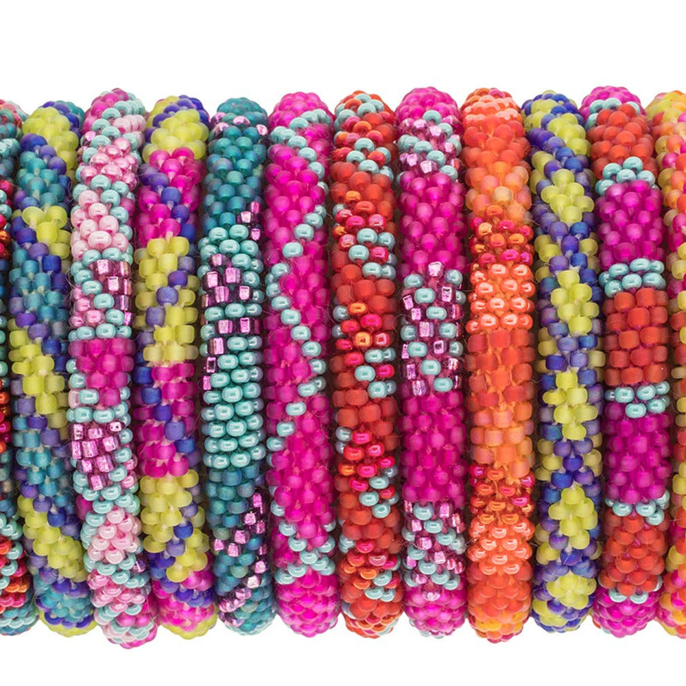 Colorful beaded bracelets arranged in a row on a white background