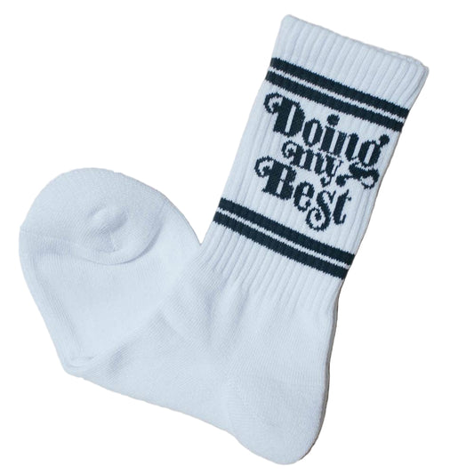 White sock with 'Doing my Best' text on a beige background
