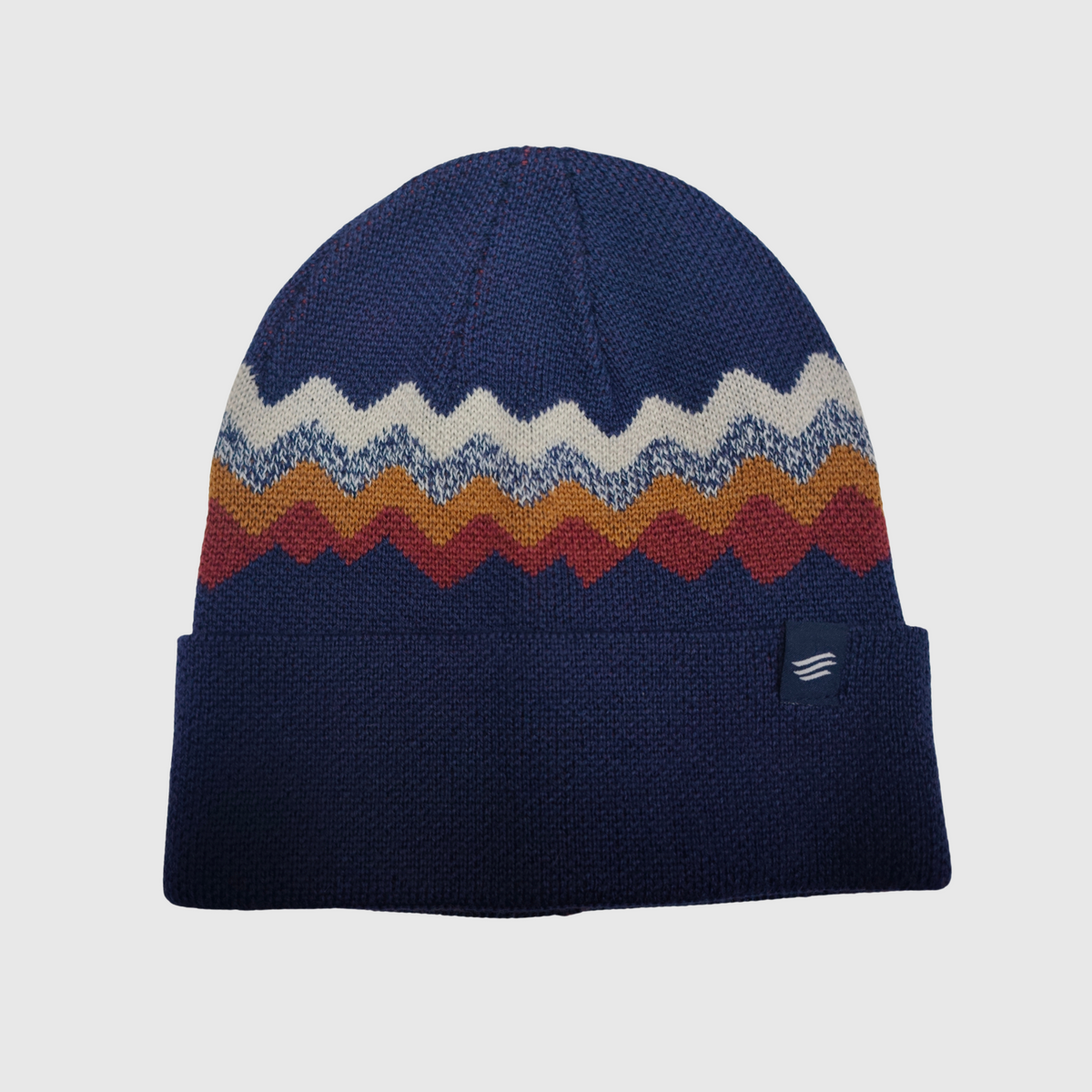 Navy blue beanie with colorful zigzag pattern on a light gray background