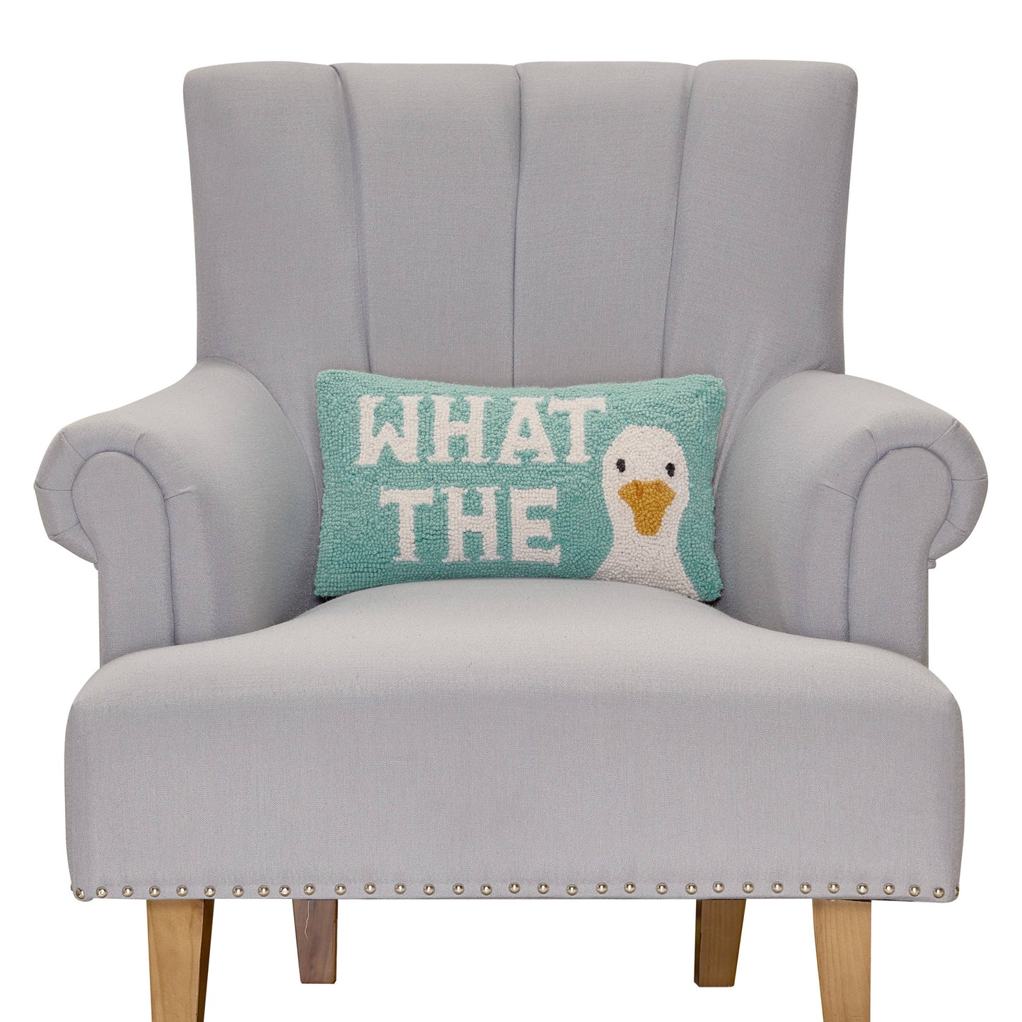 Gray armchair with a decorative pillow featuring a duck illustration and text on a white background