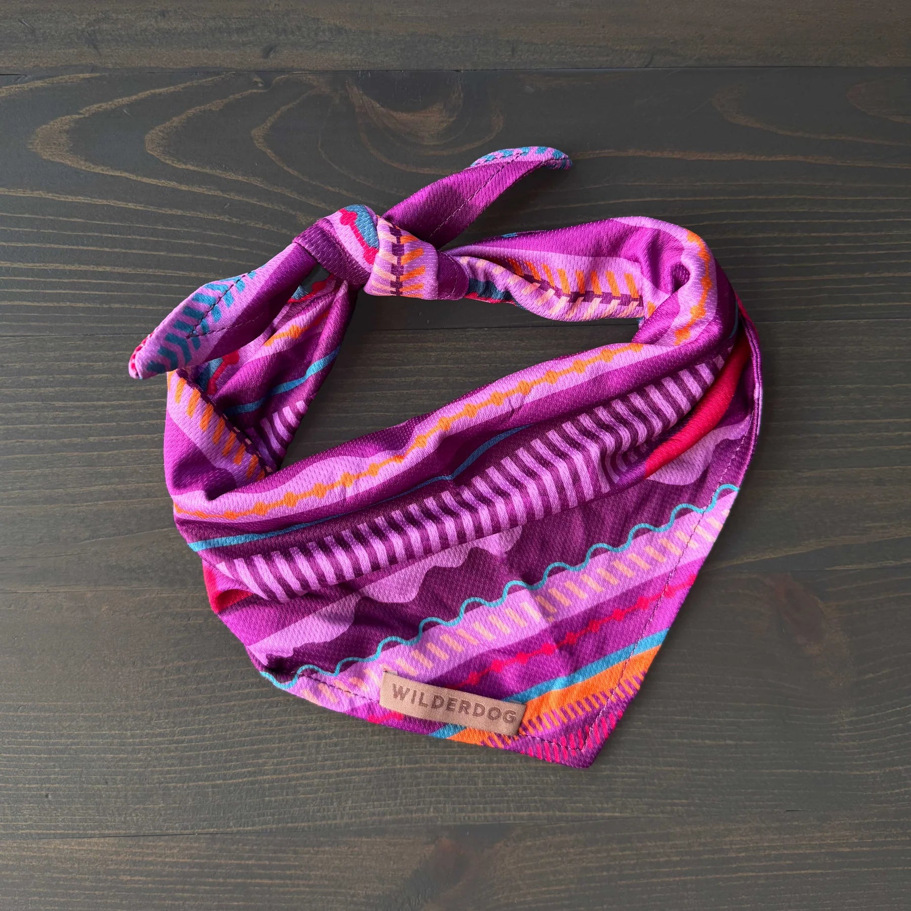 Colorful patterned headband on a wooden surface