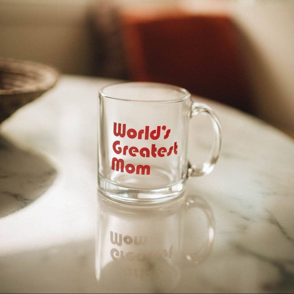 Clear mug with 'World's Greatest Mom' text on a marble surface