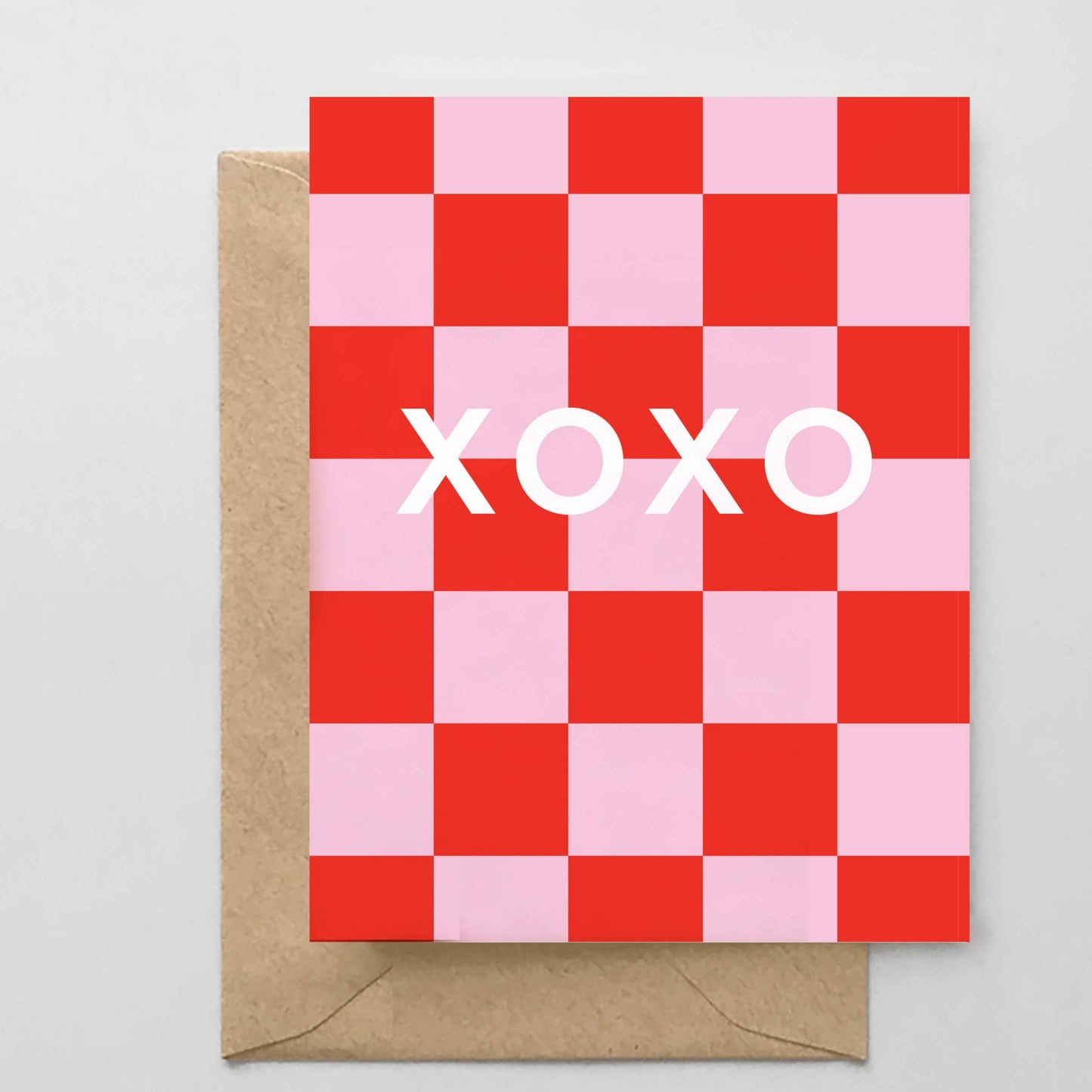 Checkered card with 'XOXO' text and brown envelope on gray background